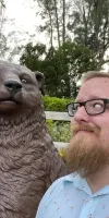 Dan looking up at a bear statue at a mini golf course in southern Florida